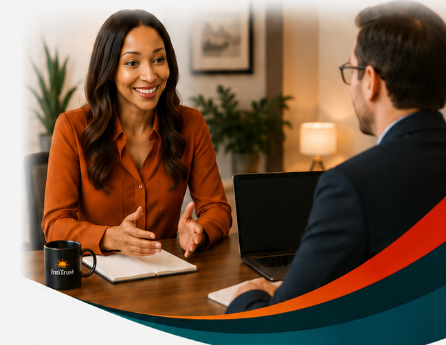IntiTrust advisor speaking with a client across a desk